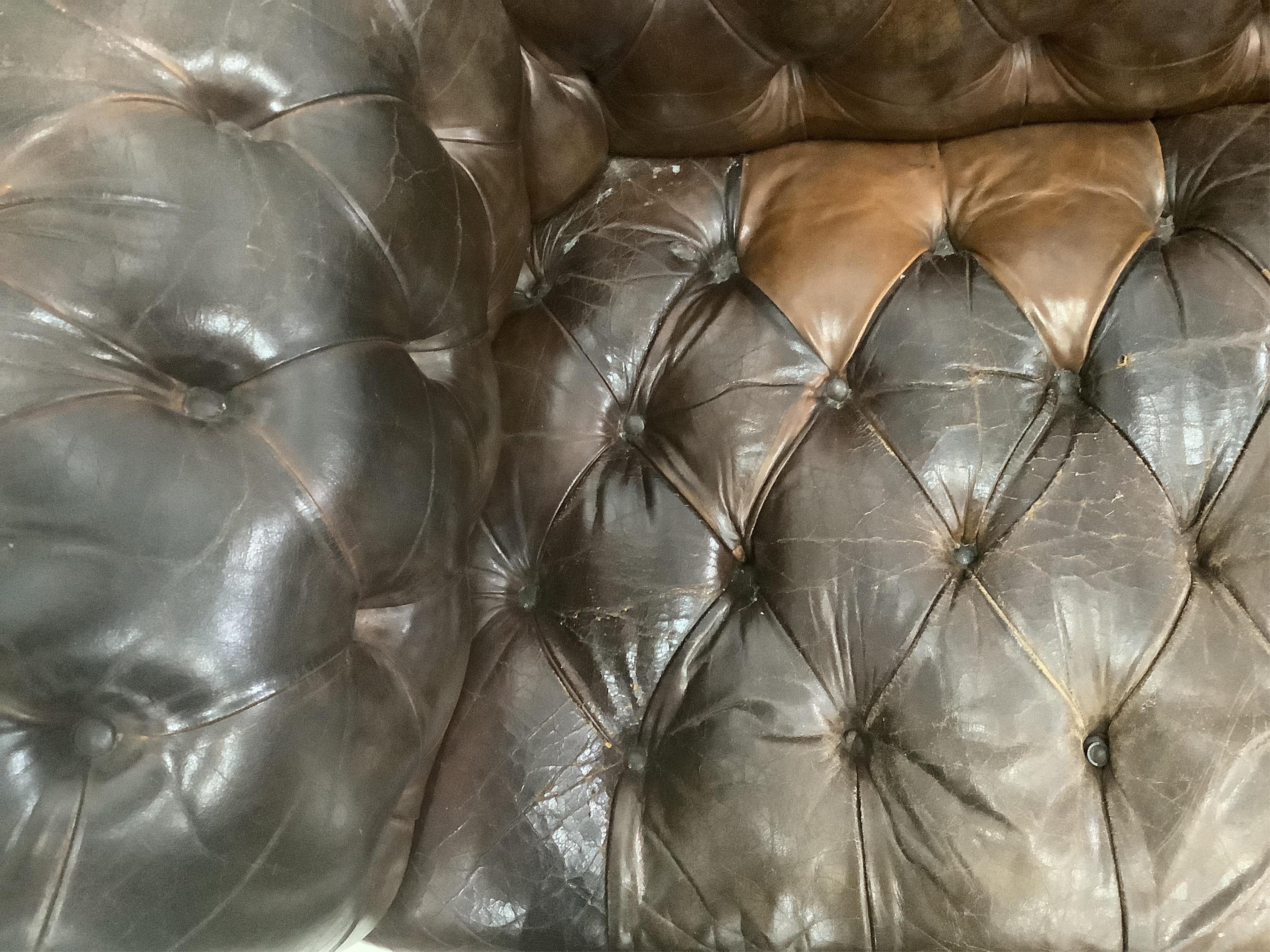 An early 20th century buttoned brown leather Chesterfield sofa, width 200cm, depth 90cm, height 72cm. Condition - fair, some patching and minor tears